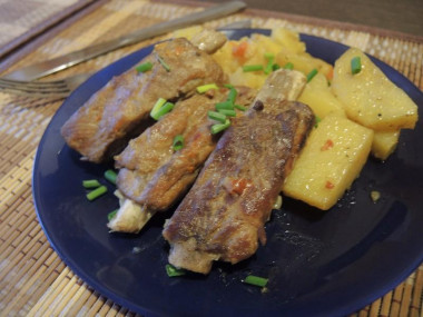 Stewed pork ribs in a slow cooker with potatoes