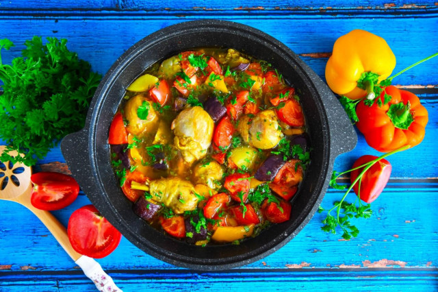 Chicken with vegetables and potatoes in a cauldron