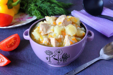 Stewed potatoes with chicken fillet in saucepan