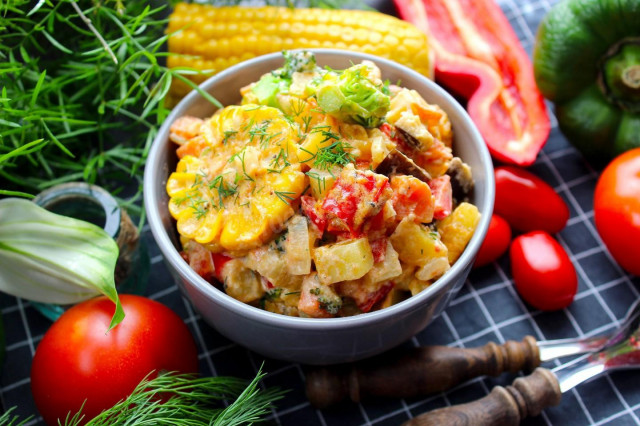 Stewed vegetables in sour cream in a frying pan