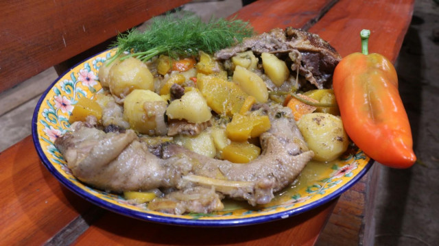 Goose stewed in vegetables and fruits in a cauldron