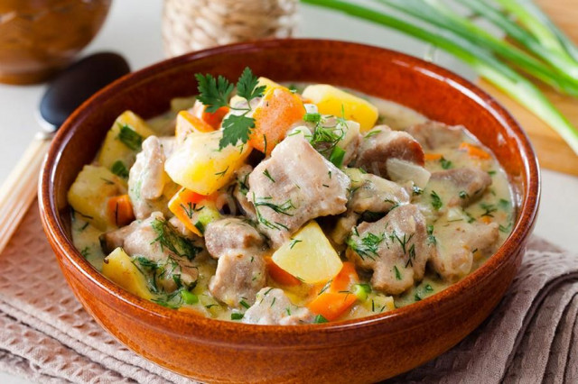 Stewed meat with sour cream and vegetables in a slow cooker