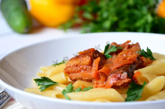 Hake fish stewed in tomato paste in a frying pan