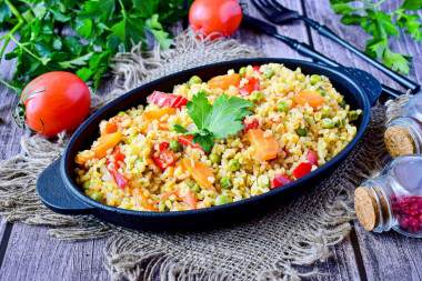 Bulgur with vegetables in a frying pan