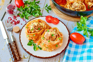 Pasta nests with minced meat in a frying pan