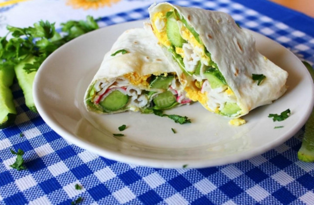 Pita bread roll with crab sticks and cucumber