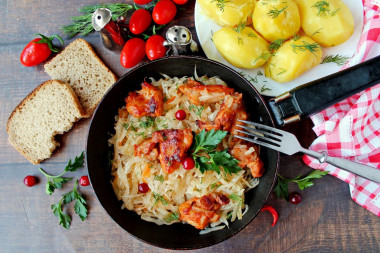 Chicken with sauerkraut in a frying pan