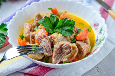 Pork with onions and carrots in a frying pan