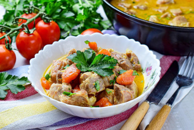 Pork with onions and carrots in a frying pan