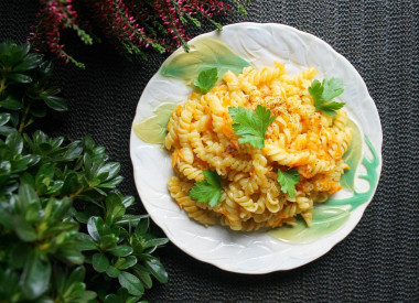 Pasta with carrots and onions in a frying pan