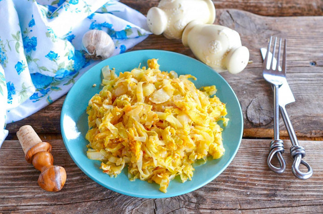 Cabbage with egg fried in a frying pan