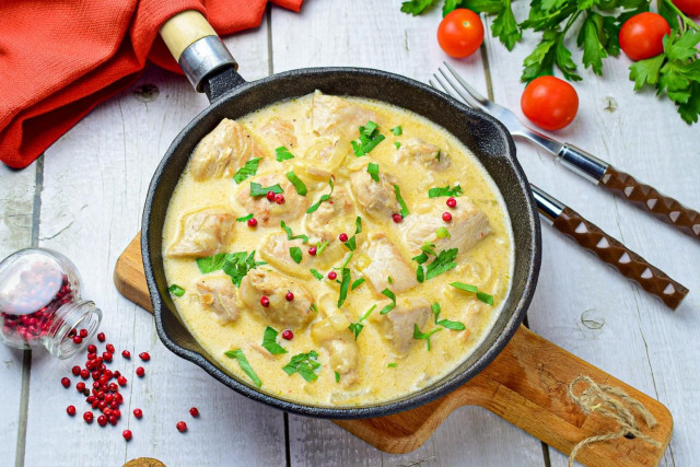 Chicken fillet in sour cream in a frying pan