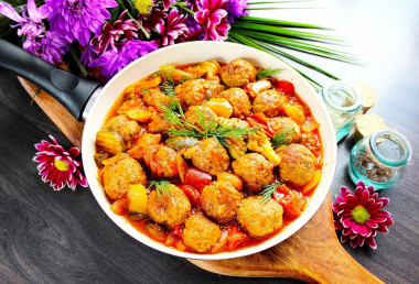 Meatballs with vegetables in a frying pan