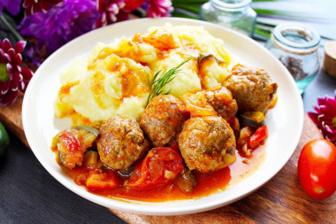 Meatballs with vegetables in a frying pan