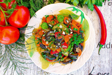 Saute zucchini and eggplant with vegetables in a frying pan