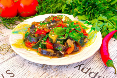 Saute zucchini and eggplant with vegetables in a frying pan