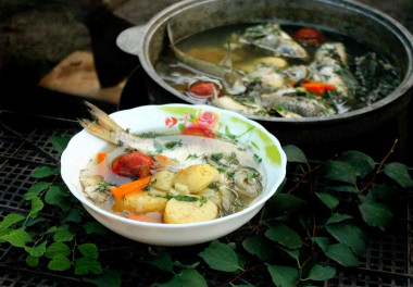 Fish soup on a fire in a cauldron