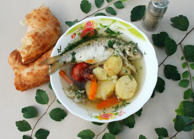 Fish soup on a fire in a cauldron