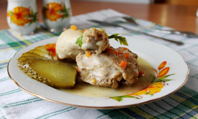 Chicken legs in sour cream sauce in a frying pan