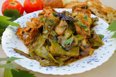 String beans with chicken on a fire in a cauldron