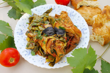 String beans with chicken on a fire in a cauldron