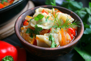 Dumplings with vegetables in a frying pan