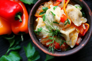 Dumplings with vegetables in a frying pan