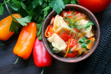 Dumplings with vegetables in a frying pan