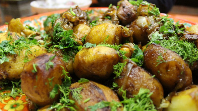 Mushrooms with potatoes and onions in a cauldron over a fire