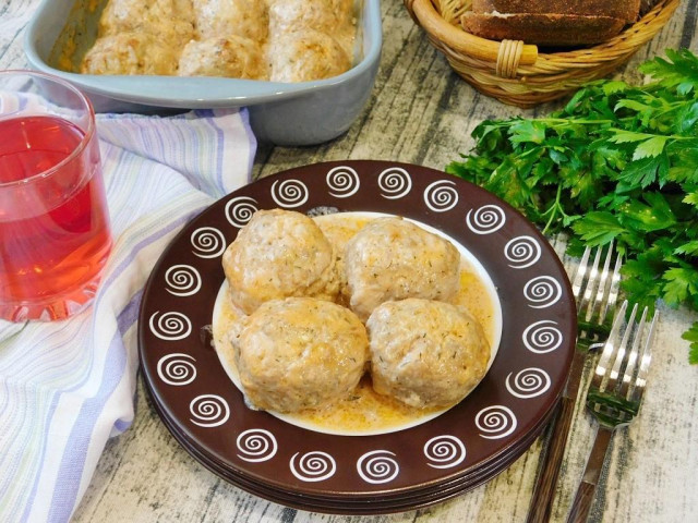 Meatballs in tomato sour cream sauce in the oven