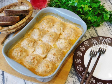 Meatballs in tomato sour cream sauce in the oven