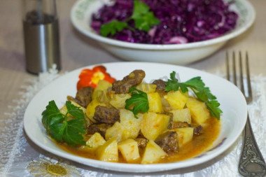 Potatoes with beef and carrots in a slow cooker