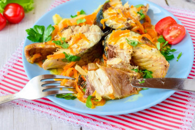 Mackerel with onions and carrots in a frying pan