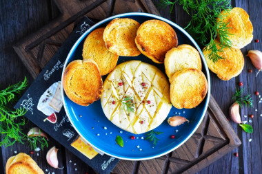 Camembert cheese baked in the oven with garlic