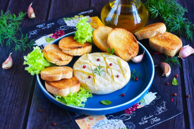 Camembert cheese baked in the oven with garlic