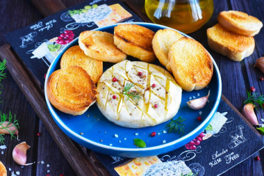 Camembert cheese baked in the oven with garlic