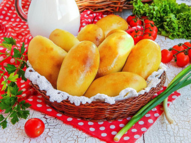 Pies with potatoes in the oven on yeast dough