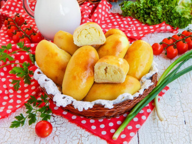 Pies with potatoes in the oven on yeast dough