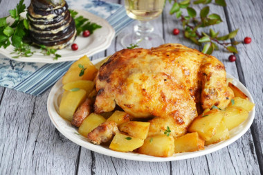 Whole chicken with potatoes in the oven with a crispy crust