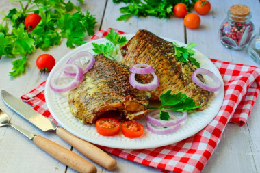 Baked crucian carp in sour cream in the oven