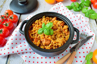 Pearl barley in a pot in the oven with meat