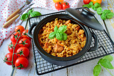 Pearl barley in a pot in the oven with meat