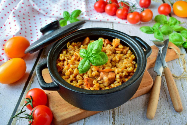 Pearl barley in a pot in the oven with meat