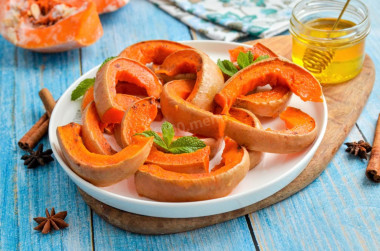 Sweet pumpkin baked in the oven with honey slices