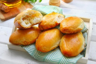 Yeast pies with cabbage in the oven