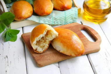 Yeast pies with cabbage in the oven