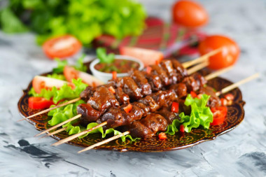 Barbecue of chicken hearts in the oven on skewers