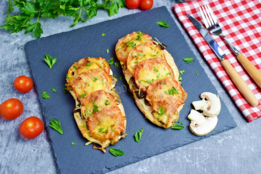 Chicken breast with mushrooms, cheese and tomatoes in the oven