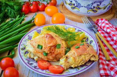 Chicken with potatoes in sour cream in the oven