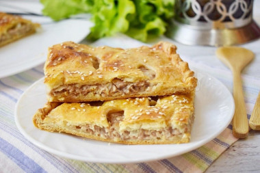 Puff pastry pie with minced meat in the oven